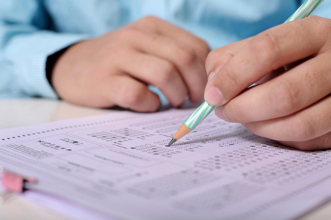 Students writing an exam and Indian police recruitment concept.